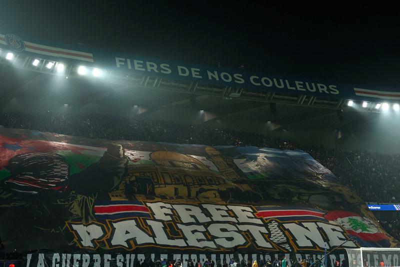 Paris' supporters hold a tifo reading Free Palestine ahead of the UEFA Champions League, League phase - Matchday 4, football match between Paris Saint-Germain (PSG) and Atletico Madrid, at the Parc des Princes stadium in Paris on November 6, 2024. - AFPPIX