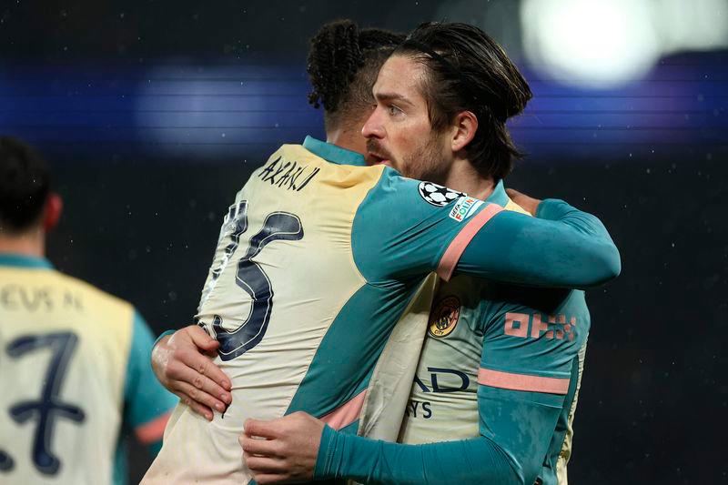 Manchester City's English midfielder #10 Jack Grealish is congratulated by teammates after scoring a goal during the UEFA Champions League, league phase football match between Paris Saint-Germain and Manchester City at the Parc des Princes Stadium in Paris on January 22, 2025. - AFPPIX