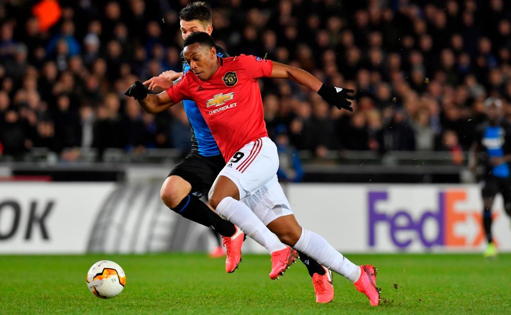 Manchester United's French forward Anthony Martial (R) fights for the ball with Club Brugge's Belgian defender Brandon Mechele, during the UEFA Europa League round of 32 first leg football match between Club Brugge's and Manchester United at the Jan Breydel Stadium in Bruges on Feb 20, 2020. — AFP