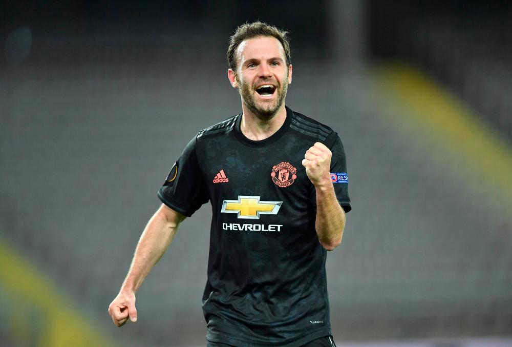 Manchester United's Spanish midfielder Juan Mata celebrates scoring during the UEFA Europa League last 16, first leg football match against Linzer ASK (LASK). — AFP
