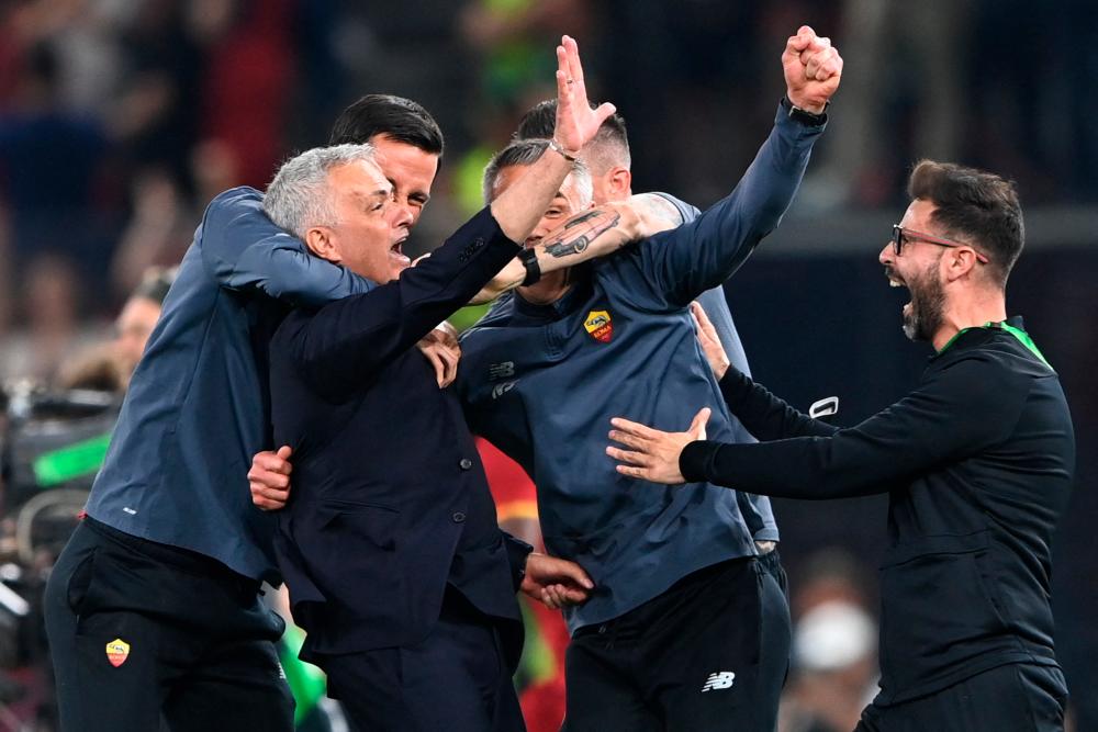 Roma's Portuguese head coach Jose Mourinho and coaching staff celebrate after winning the UEFA Europa Conference League final football match between AS Roma and Feyenoord at the Air Albania Stadium in Tirana. AFPPIX