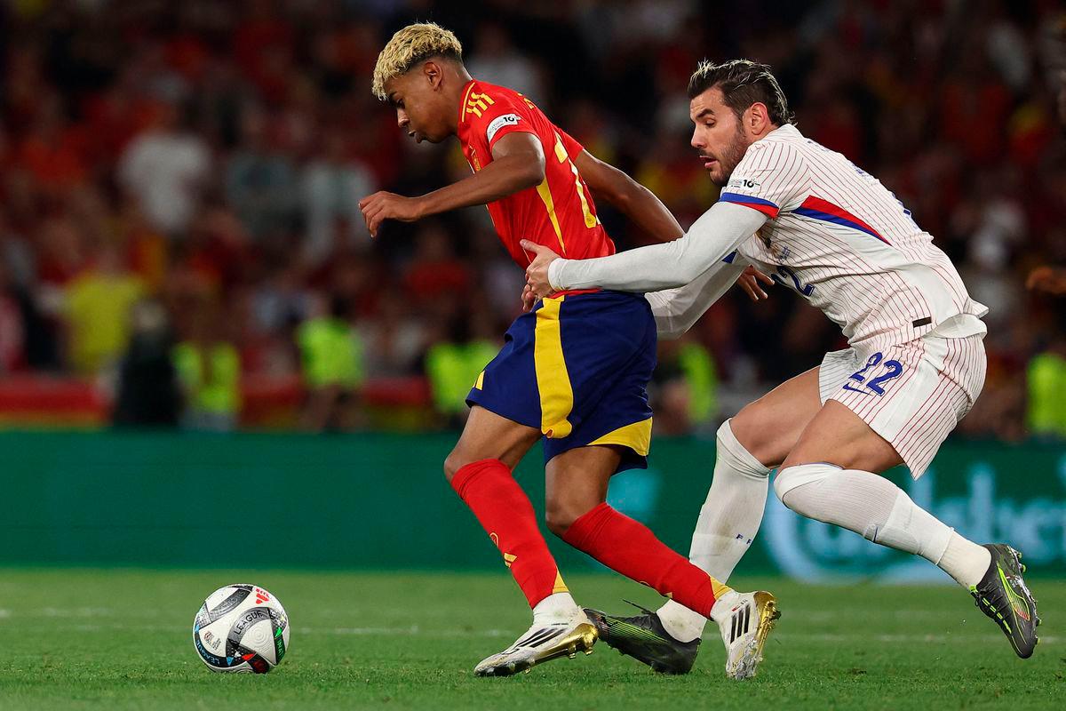 Spain’s forward #19 Lamine Yamal is pulled back by France’s defender #22 Theo Hernandez during the UEFA Nations League semi-final football match between Spain and France in Stuttgart, southwestern Germany, on June 5, 2025. AFP