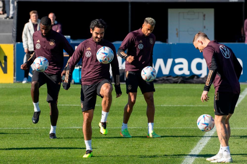 Germany’s players (L-R) Germany’s defender Antonio Ruediger, Germany’s midfielder Ilkay Gundogan and Germany’s forward Lukas Nmecha warm up during a training session, two days before the UEFA Nations League Group 3 football match between Germany and Hungary, at the DFB campus in Frankfurt am Main, western Germany, on September 21, 2022. AFPPIX