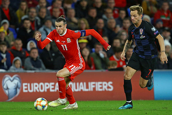 Wales’ striker Gareth Bale (L) vies with Croatia’s midfielder Ivan Rakitic during the Euro 2020 football qualification match between Wales and Croatia at Cardiff City Stadium, Cardiff on October 13, 2019. — AFP