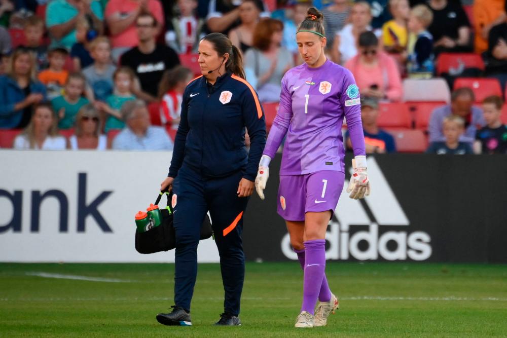 Netherlands’ goalkeeper Sari van Veenendaal (R) has to leave the game injured, after a collision with two of her own players during the UEFA Women’s Euro 2022 Group C football match between Netherlands and Sweden at Bramall Lane in Sheffield, northern England on July 9, 2022/AFPPix