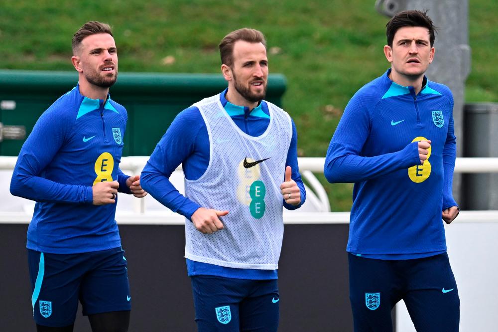 England's midfielder Jordan Henderson (L), Harry Kane (C) and Harry Maguire attend a team training session at St George's Park in Burton-on-Trent, central England, on March 21, 2023 ahead of of their UEFA EURO 2024 qualifier football match against Italy. AFPPIX