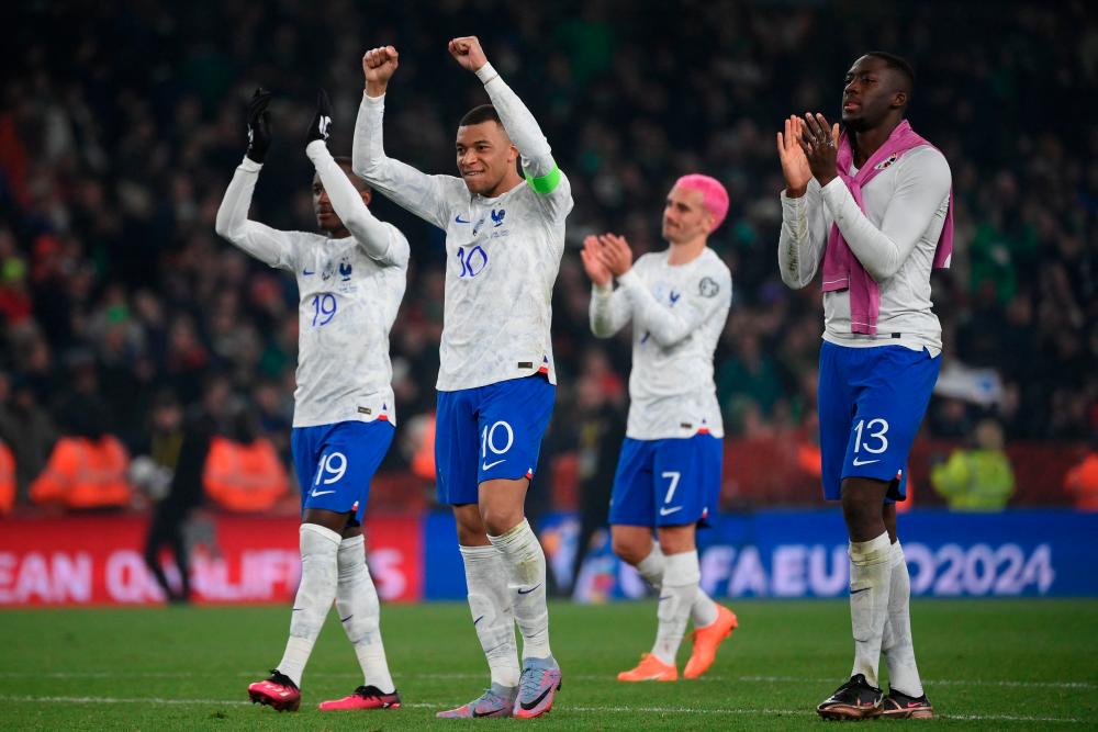 Kylian Mbappe (2L), Moussa Diaby (L), Antoine Griezmann (2R) and Ibrahima Konate (R) applaud fans on the final whistle in the UEFA Euro 2024 group B qualification football match between Republic of Ireland and France at Aviva Stadium in Dublin, Ireland on March 27, 2023. AFPPIX