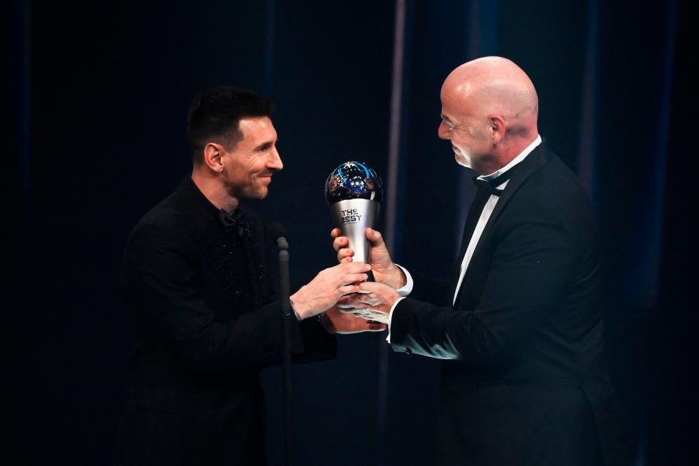 Argentina and Paris Saint-Germain forward Lionel Messi (L) receives from FIFA President Gianni Infantino the Best FIFA Men’s Player award during the Best FIFA Football Awards 2022 ceremony in Paris on February 27, 2023. AFPPIX