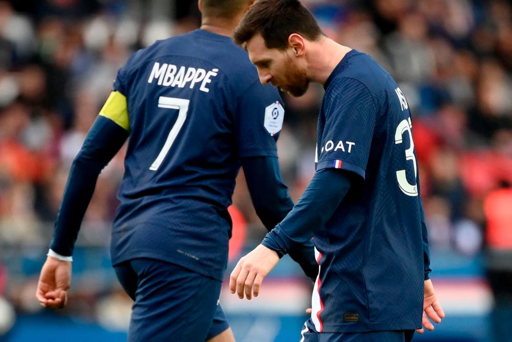 Paris Saint-Germain forward Lionel Messi (R) and Kylian Mbappe react during the French L1 football match between Paris Saint-Germain (PSG) and Stade Rennais FC at The Parc des Princes Stadium in Paris on March 19, 2023. AFPPIX