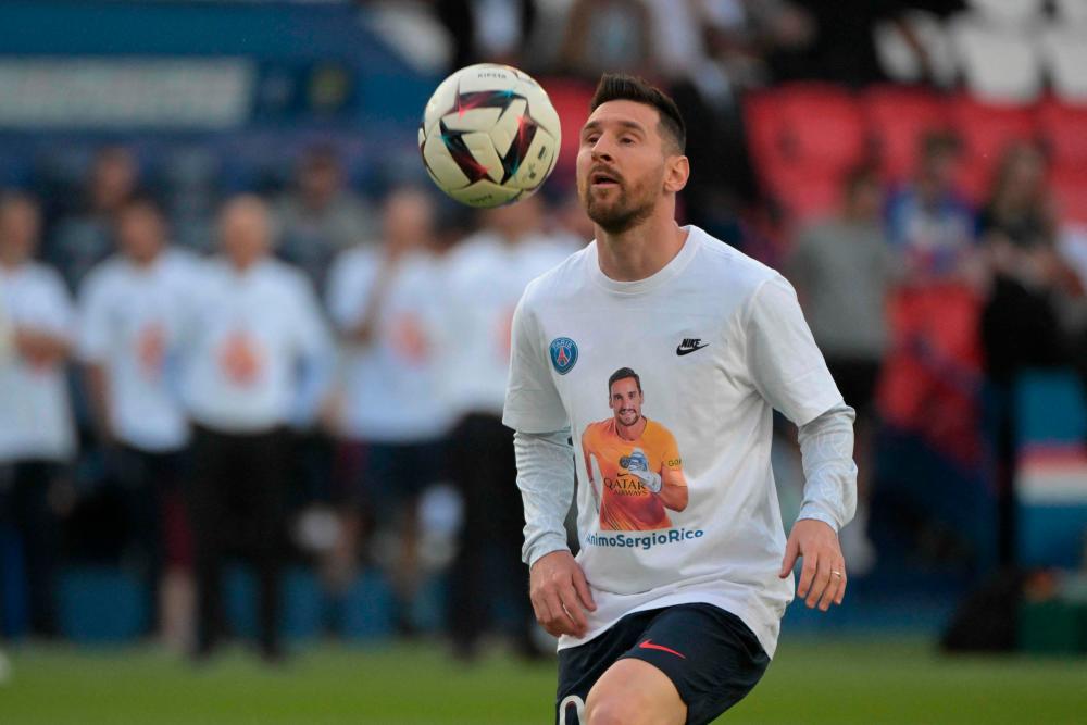 Paris Saint-Germain’s Argentine forward Lionel Messi warms up as he wears a T-shirt with a portrait of Paris Saint-Germain’s Spanish goalkeeper Sergio Rico, who is in serious condition after a horse-riding accident, prior to the French L1 football match between Paris Saint-Germain (PSG) and Clermont Foot 63 at the Parc des Princes Stadium in Paris on June 3, 2023/AFPPix