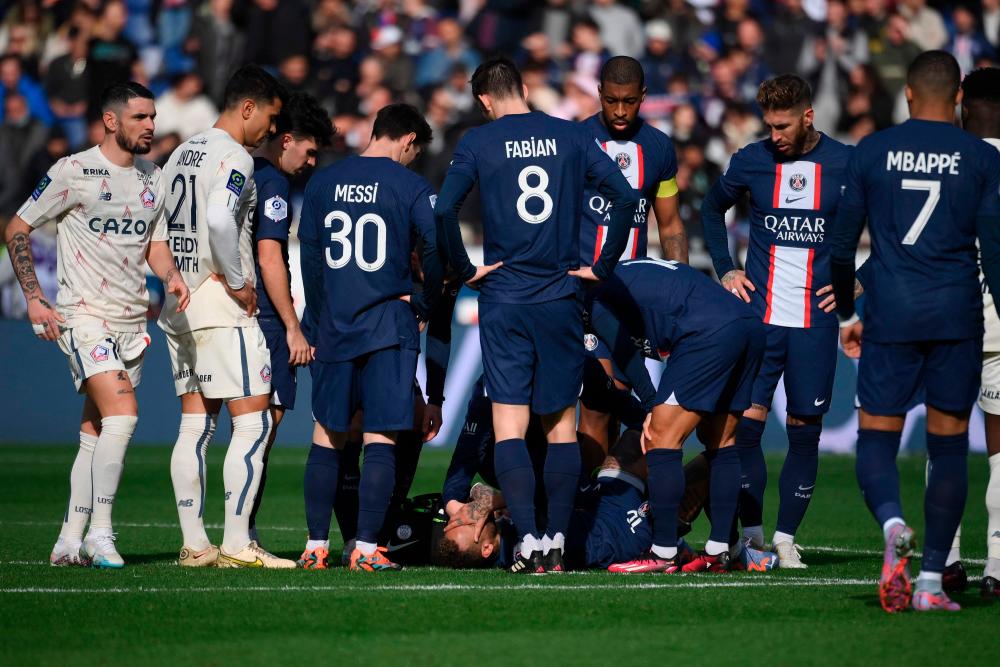 Paris Saint-Germain's Neymar (C) reacts after getting hurt during the French L1 football match between Paris Saint-Germain (PSG) and Lille LOSC at The Parc des Princes Stadium in Paris on February 19, 2023. AFPPIX