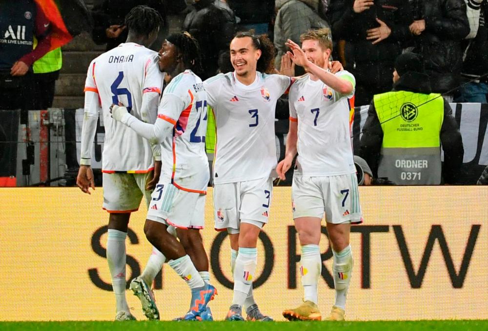 Belgium's midfielder Kevin De Bruyne (R) celebrates scoring the 1-3 goal with his team-mates during the international friendly football match Germany v Belgium in Cologne, western Germany, on March 28, 2023/AFPPix