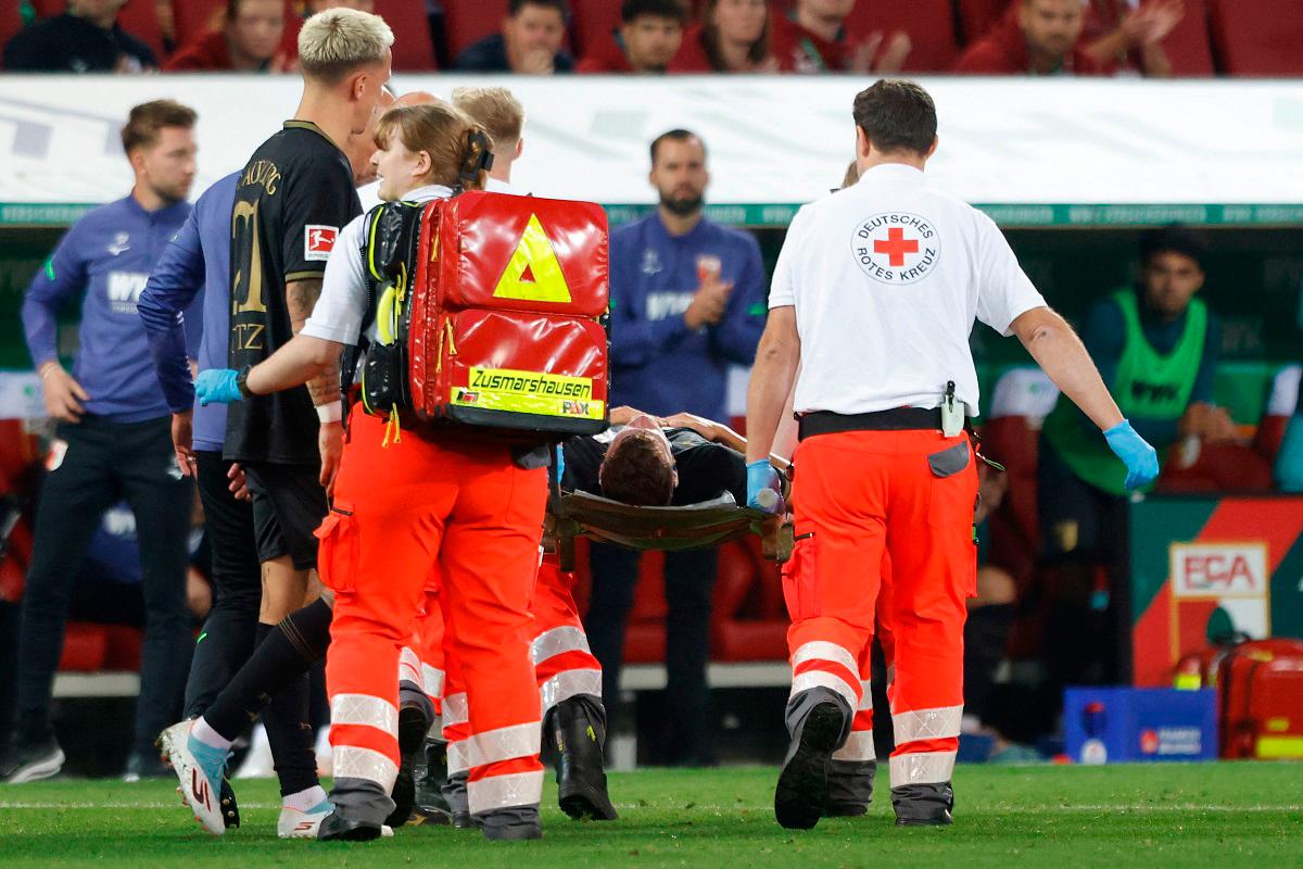 Augsburg’s German midfielder #19 Robin Fellhauer is stretchered off following a clash of heads during the German first division Bundesliga football match between FC Augsburg and FC Bayern Munich. - Michaela STACHE / AFP