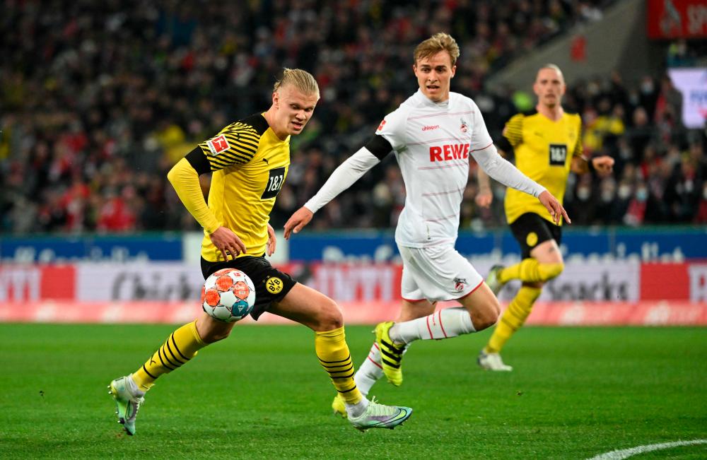 Dortmund’s Norwegian forward Erling Braut Haaland (L) and Cologne’s German defender Luca Kilian vie for the ball during the German first division Bundesliga football match FC Cologne v Borussia Dortmund in Cologne, western Germany, on March 20, 2022. AFPPIX