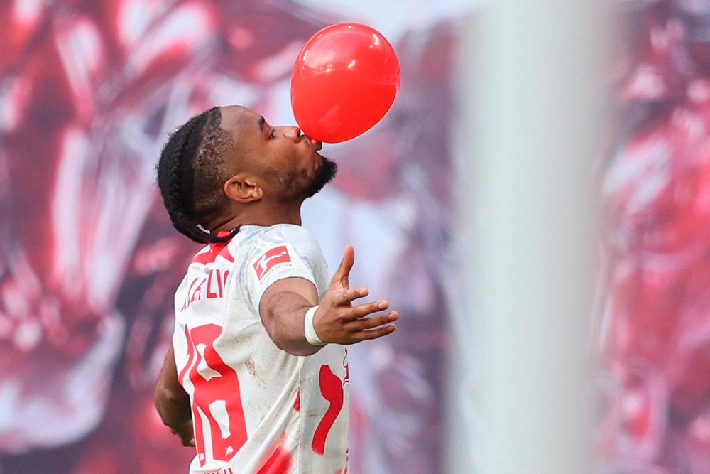 Leipzig’s French forward Christopher Nkunku celebrates scoring with a balloon before the goal was disallowed during the German first division Bundesliga football match between RB Leipzig and Werder Bremen in Leipzig on May 14, 2023/AFPPix