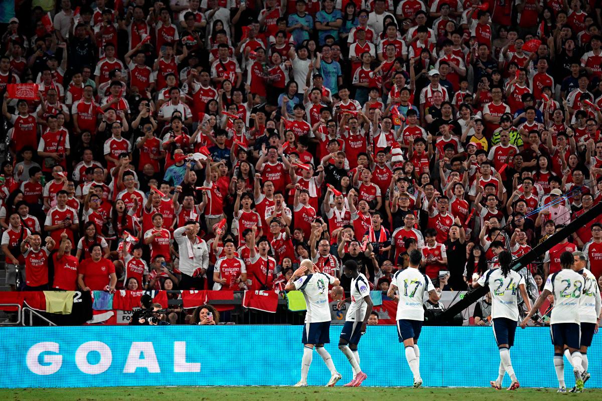 Tottenham Hotspur’s players celebrate a goal in front of Arsenal fans during their friendly exhibition football match at the Kai Tak Stadium in Hong Kong on July 31, 2025. - Peter PARKS / AFP