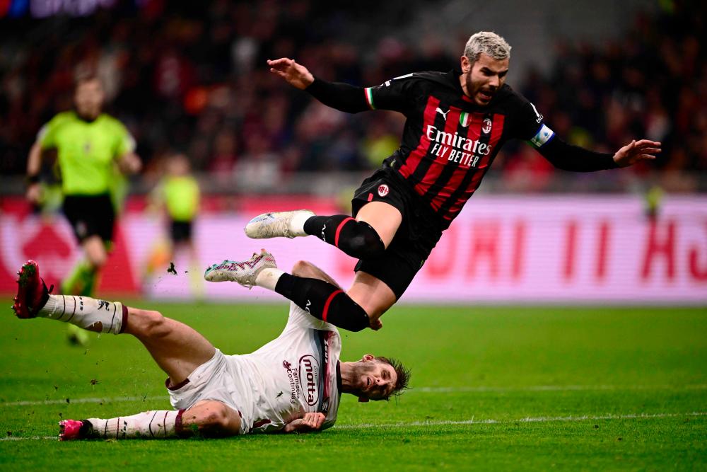 Salernitana’s Slovakian defender Norbert Gyomber (L) tackles AC Milan’s French defender Theo Hernandez during the Italian Serie A football match between AC Milan and US Salernitana 1919 at the San Siro stadium in Milan on March 13, 2023. AFPPIX