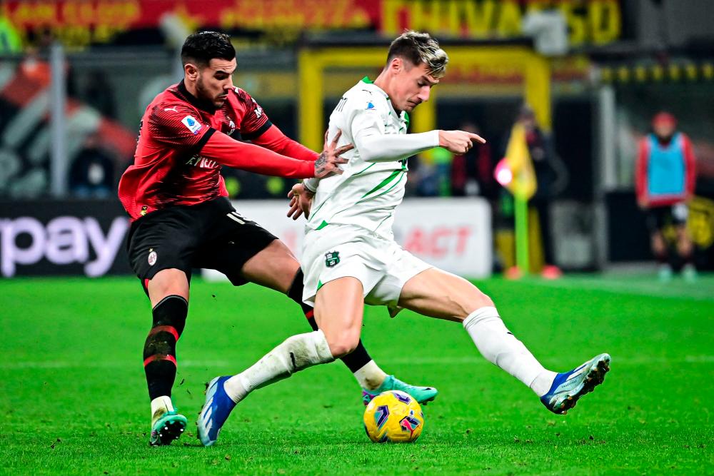 AC Milan’s French defender #19 Theo Hernandez (L) fights for the ball with Sassuolo’s Italian forward #9 Andrea Pinamonti during the Italian Serie A football match between AC Milan and Sassuolo at the San Siro stadium, in Milan on December 30, 2023/AFPPix