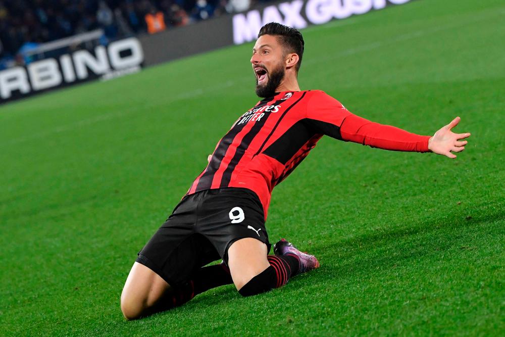 AC Milan’s French forward Olivier Giroud celebrates after scoring a goal during the Italian Serie A football match between SSC Napoli and Milan AC at the Diego Armando Maradona stadium in Naples on March 6, 2022. AFPPIX