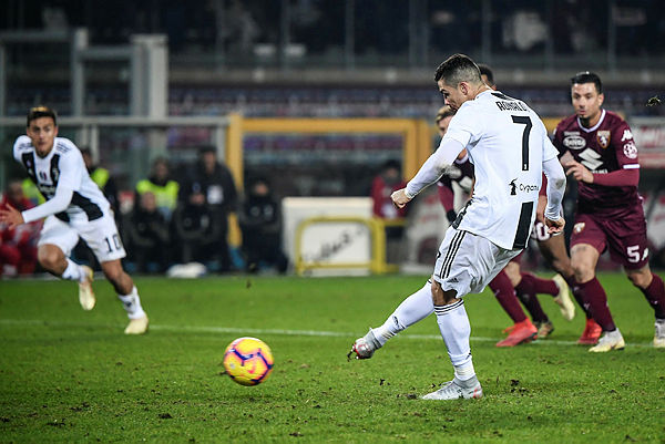 Juventus’ Portuguese forward Cristiano Ronaldo shoots a penalty kick to open the scoring during the Italian Serie A football match Torino vs Juventus on Dec 15, 2018 at the Olympic stadium in Turin. — AFP