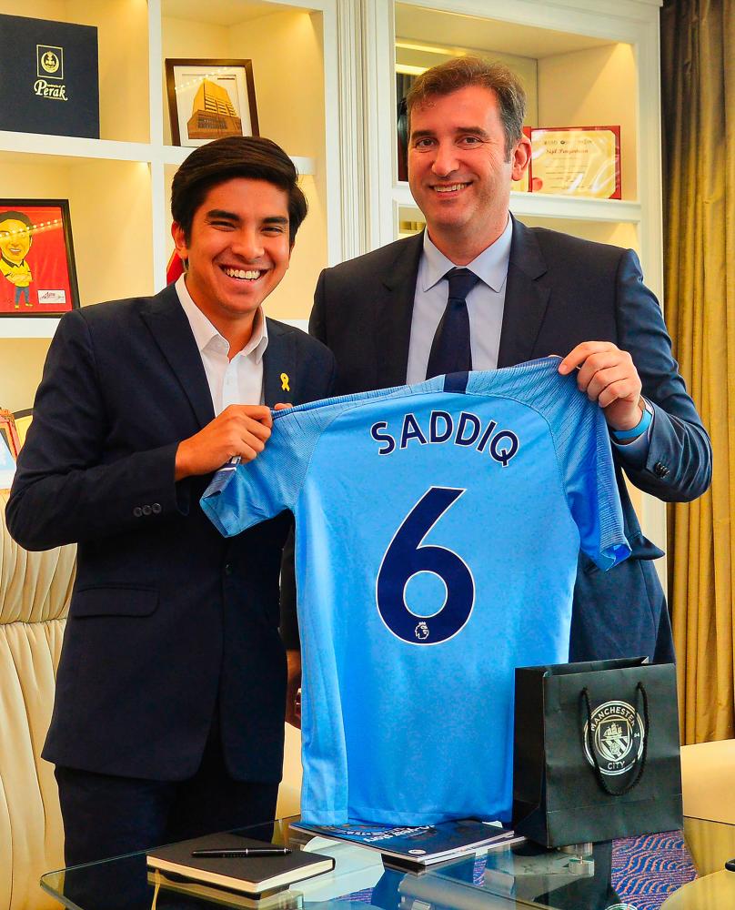 This handout photo from the Youth and Sports Ministry taken on May 23, 2019 and released on May 24, 2019 shows Youth and Sports Minister Syed Saddiq (L) and Manchester City's Spanish Chief Executive Officer Ferran Soriano posing for a picture in Putrajaya. - AFP