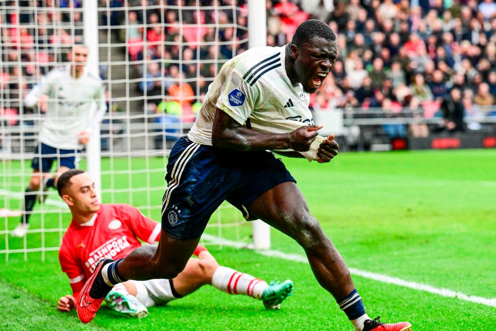 Ajax’s Brian Brobbey celebrates after scoring a goal during the Dutch Eredivisie football match between PSV Eindhoven and Ajax Amsterdam at the Phillips stadium on October 29, 2023 in Eindhoven/AFPPix
