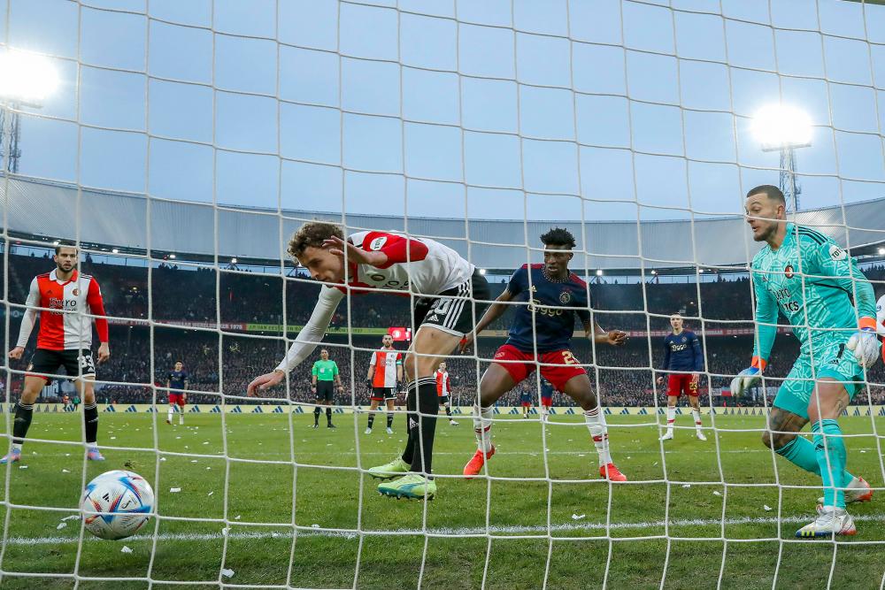Feyenoord’s Dutch midfielder Mats Wieffer (CL) scores an own goal during the Dutch Eredivisie football match between Feyenoord Rotterdam and Ajax Amsterdam at Feyenoord Stadion de Kuip in Rotterdam on January 22, 2023. AFPPIX