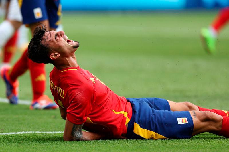 Spain’s defender #02 Marc Pubill reacts as he falls during the men’s group C football match between Uzbekistan and Spain of the the Paris 2024 Olympic Games at the Parc des Princes in Paris on July 24, 2024 / AFPPIX