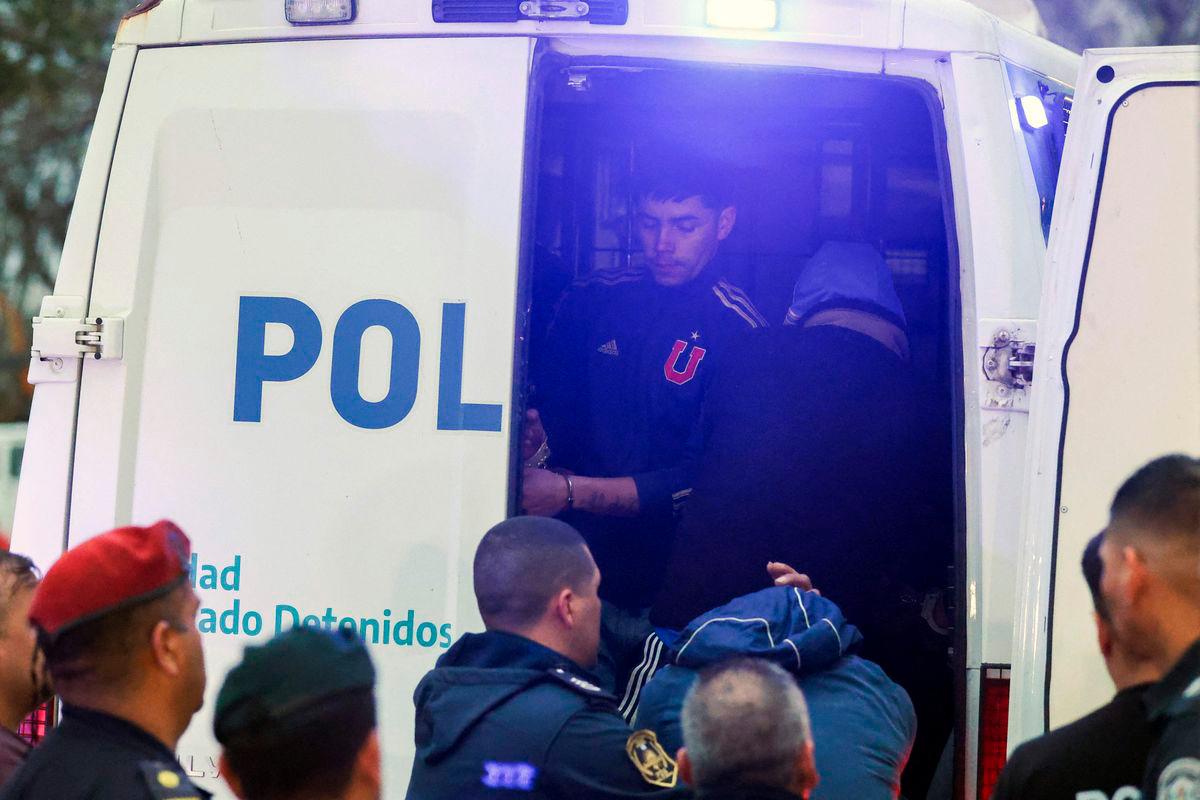 Detained fans of Universidad de Chile get into a police vehicle to be transferred by the Buenos Aires Province Police from a police station in Avellaneda, Buenos Aires province, Argentina. AFP