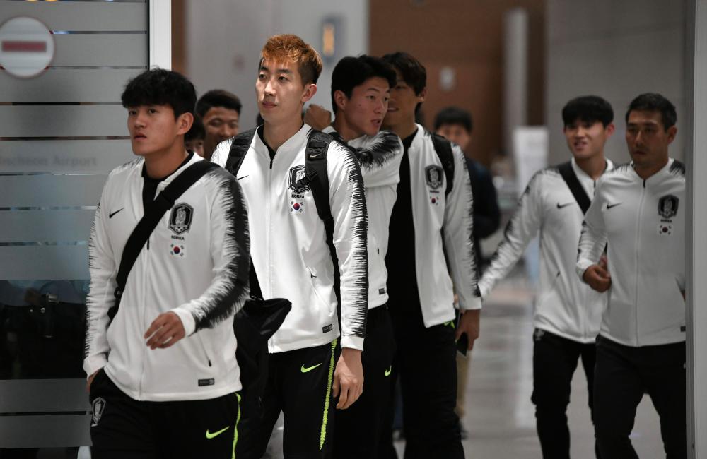 South Korean national football team players arrive at Incheon airport in Incheon early on October 17, 2019 after the World Cup 2022 Qualifying Asian zone Group H football match between South Korea and North Korea which held at Kim Il Sung Stadium in Pyongyang. - AFP