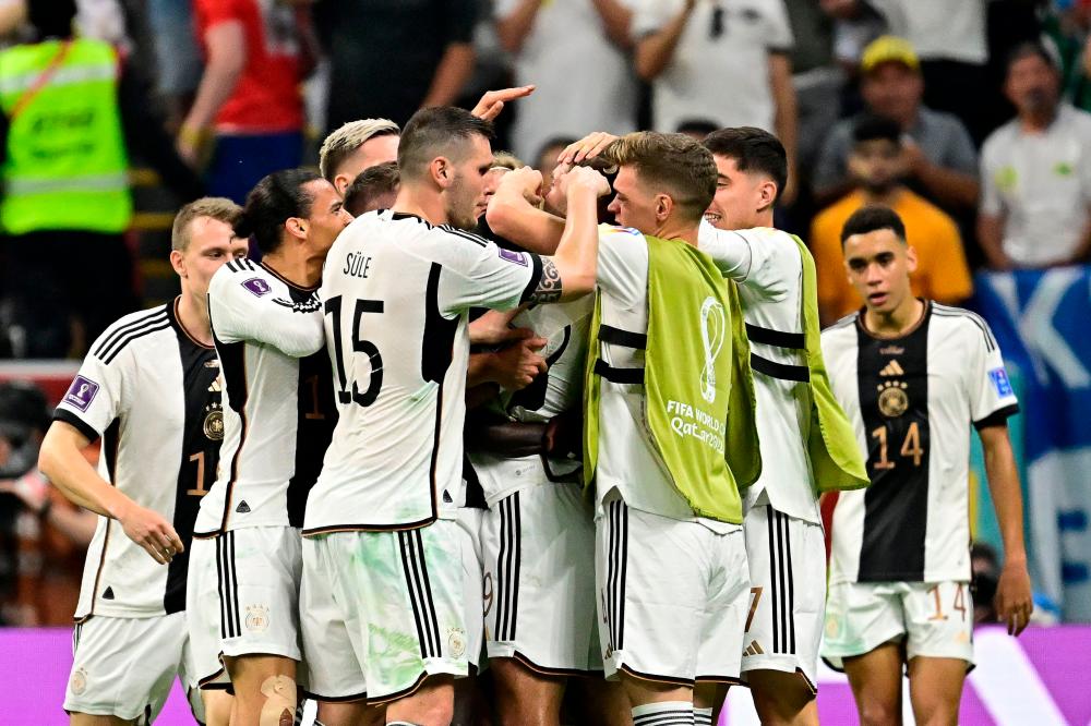 Germany’s players celebrate after Germany’s forward #09 Niclas Fullkrug scored their team’s first goal during the Qatar 2022 World Cup Group E football match between Spain and Germany at the Al-Bayt Stadium in Al Khor, north of Doha on November 27, 2022/AFPPix