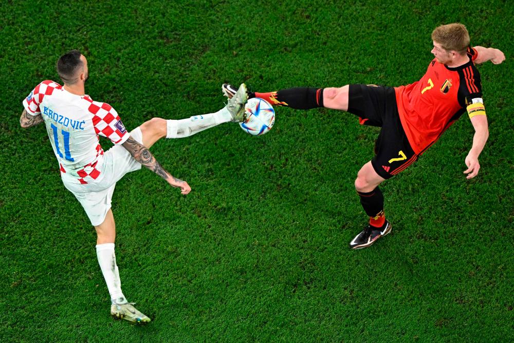 Croatia’s midfielder #11 Marcelo Brozovic (L) fights for the ball with Belgium’s midfielder #07 Kevin De Bruyne during the Qatar 2022 World Cup Group F football match between Croatia and Belgium at the Ahmad Bin Ali Stadium in Al-Rayyan, west of Doha on December 1, 2022. AFPPIX