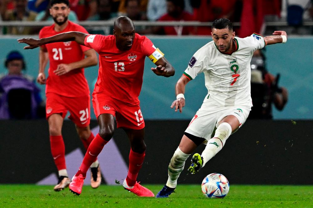 Canada’s midfielder #13 Atiba Hutchinson fights for the ball with Morocco’s midfielder #07 Hakim Ziyech during the Qatar 2022 World Cup Group F football match between Canada and Morocco at the Al-Thumama Stadium in Doha on December 1, 2022. AFPPIX