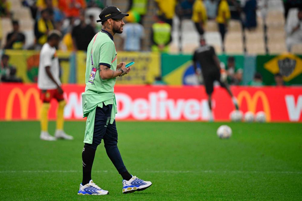 Brazil’s forward #10 Neymar checks out the conditions on the pitch ahead of the Qatar 2022 World Cup Group G football match between Cameroon and Brazil at the Lusail Stadium in Lusail, north of Doha on December 2, 2022/AFPPix
