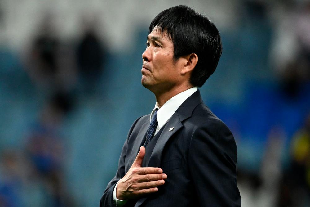 Japan's coach #00 Hajime Moriyasu greets the fans after his team's defeat in the Qatar 2022 World Cup round of 16 football match between Japan and Croatia at the Al-Janoub Stadium in Al-Wakrah, south of Doha on December 5, 2022. - AFPPIX