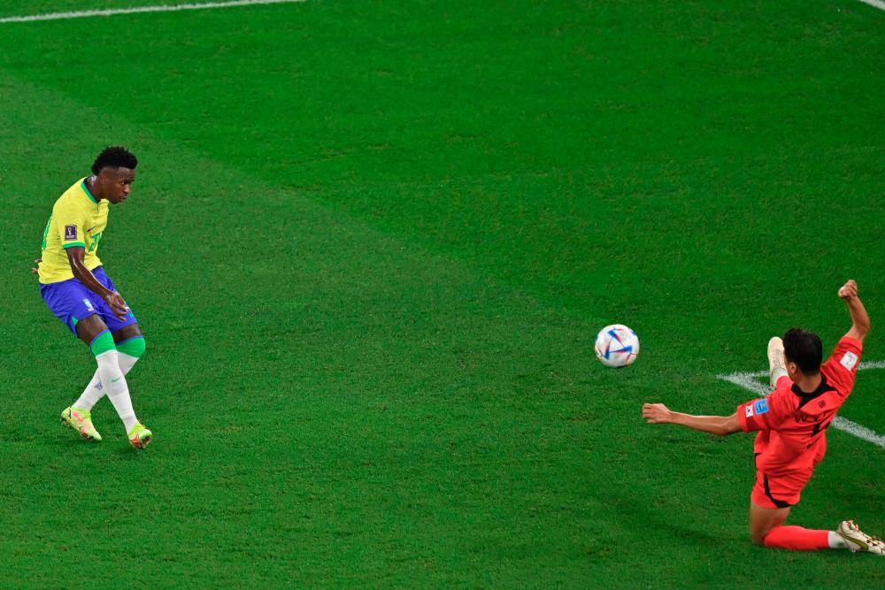 Brazil's forward Vinicius Junior scores his team's first goal during the Qatar 2022 World Cup round of 16 football match between Brazil and South Korea/AFPPIX