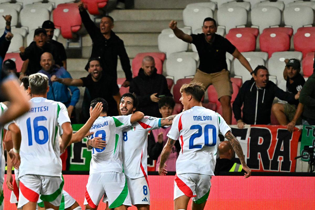 Italy’s midfielder Sandro Tonali celebrates with team mates after scoring the 4-5 winning goal during the 2026 World Cup qualifiers Europe zone group I football match between Israel and Italy on September 8, 2025 in Debrecen, Hungary. - Attila KISBENEDEK / AFP