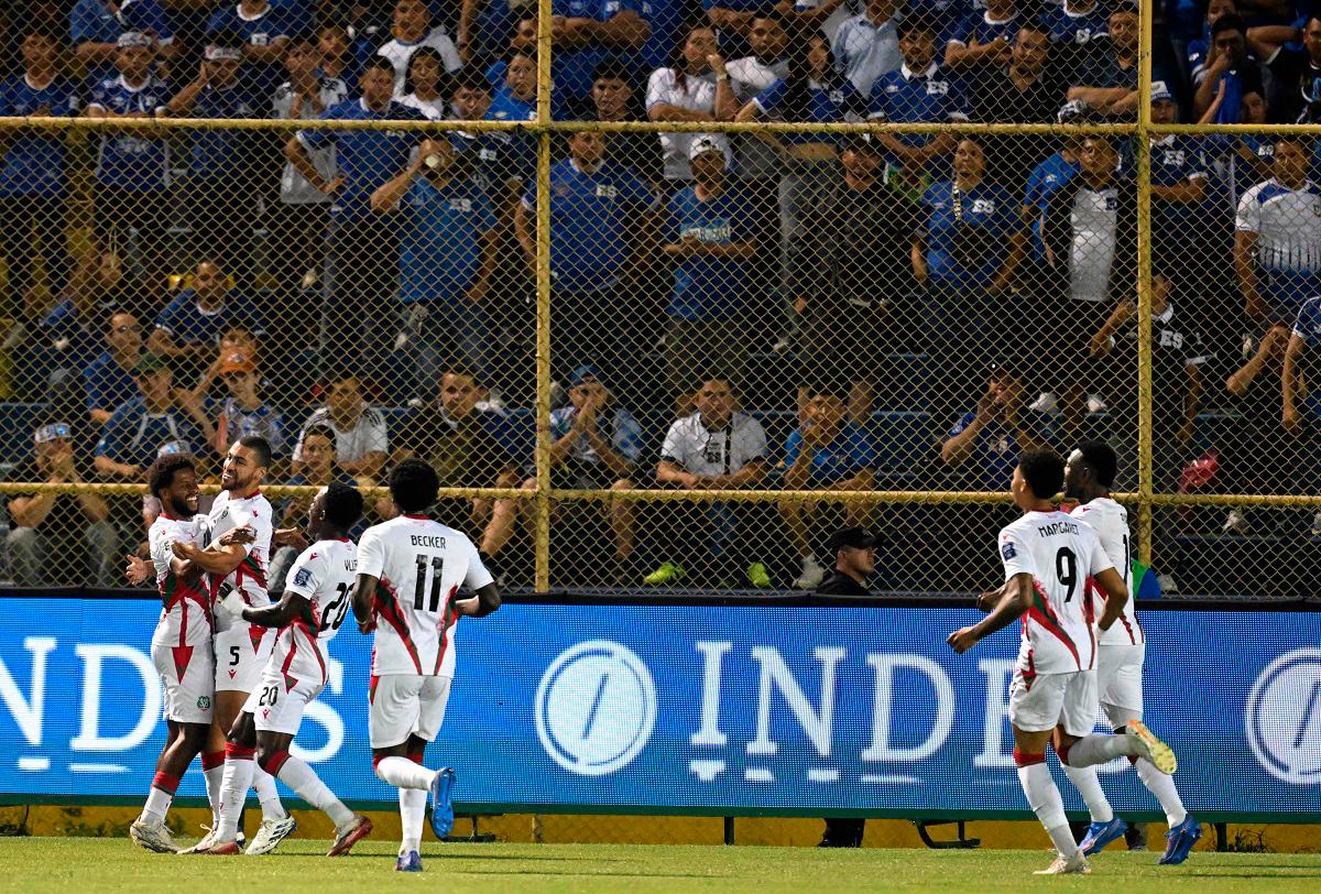 Suriname players celebrate their second goal during the 2026 FIFA World Cup Concacaf qualifier football match between El Salvador and Suriname. - MARVIN RECINOS / AFP