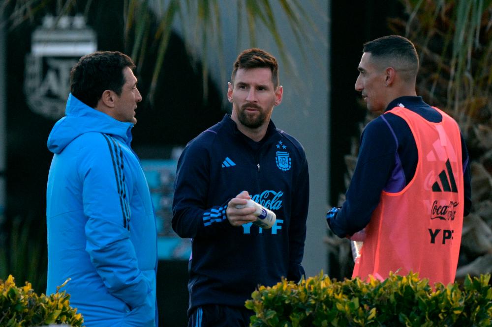 Lionel Messi and Angel Di Maria (R) chat during a training session in Ezeiza, Buenos Aires, on August 5, 2023, ahead of FIFA World Cup 2026 qualifier football matches against Ecuador on August 7 in Buenos Aires and with Bolivia on August 12 in La Paz. AFPPIX