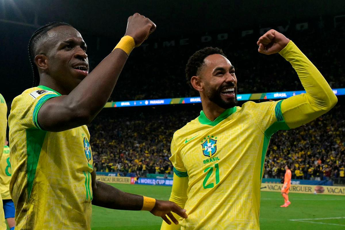 Brazil’s forward #10 Vinicius Jr (L) celebrates with teammate forward #21 Matheus Cunha (R) after scoring his team’s first goal during the 2026 FIFA World Cup South American qualifiers football match between Brazil and Paraguay at the Neo Quimica Arena in Sao Paulo, Brazil, on June 10, 2025. AFP