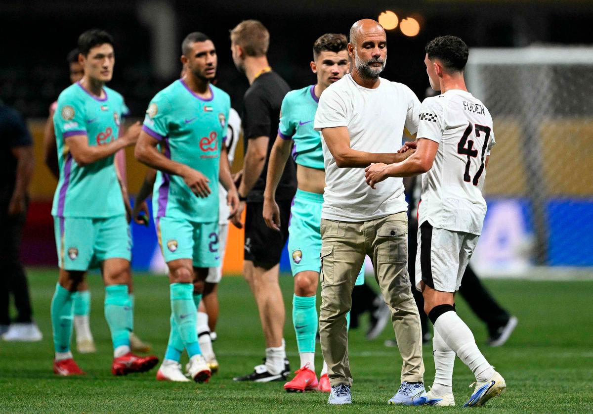 Manchester City’s Spanish head coach Pep Guardiola greets Manchester City’s English midfielder #47 Phil Foden at the end of the FIFA Club World Cup 2025 Group G football match between England’s Manchester City and UAE’s Al Ain FC at the Mercedes-Benz stadium in Atlanta on June 22, 2025 - AFP