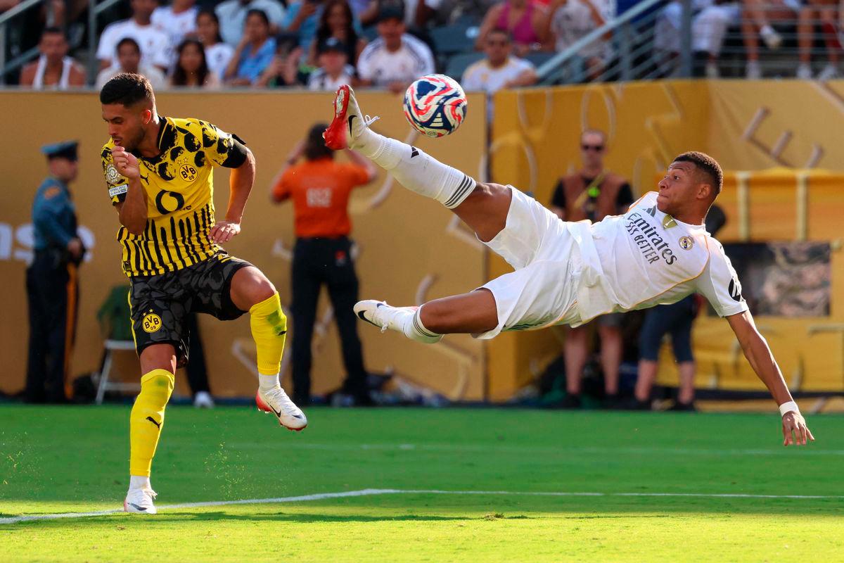 Borussia Dortmund’s Brazilian defender #02 Yan Couto fights for the ball with Real Madrid’s French forward #09 Kylian Mbappe as he scores his team’s third goal during the FIFA Club World Cup 2025 quarterfinal football match between Spain’s Real Madrid and Germany’s Borussia Dortmund at the MetLife stadium in East Rutherford, New Jersey on July 5, 2025 - AFP