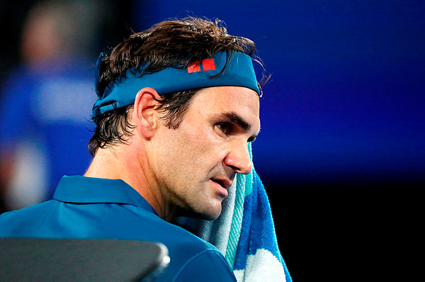 Switzerland’s Roger Federer rests during a break in his men’s singles match against Taylor Fritz of the US on day five of the Australian Open — AFP