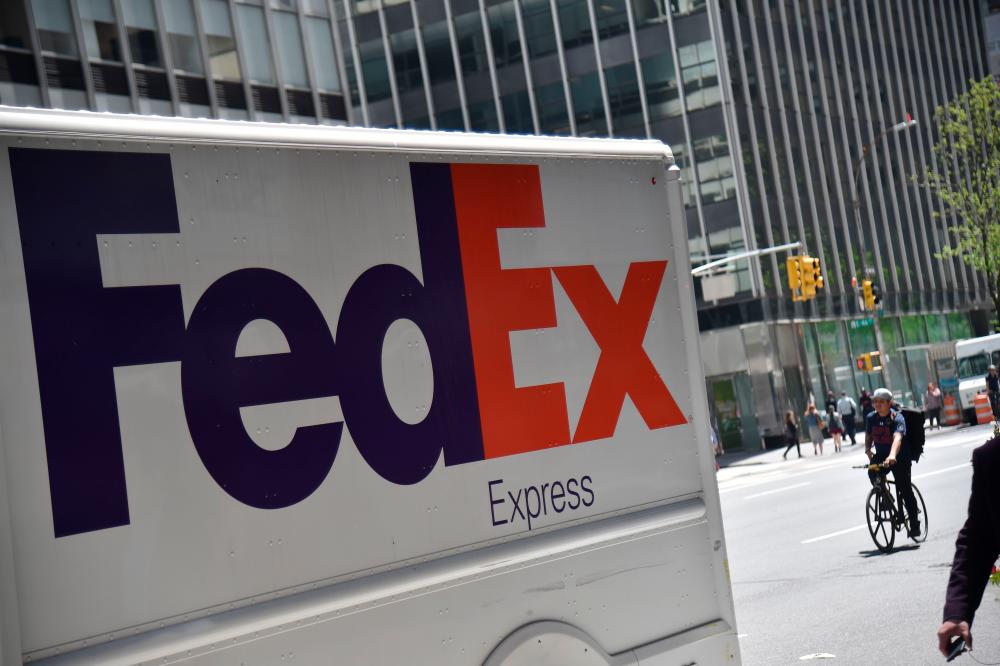A FedEx truck is seen on 3rd Avenue in New York City. FedEx says the staff downsizing in Europe will take place over an 18-month period. – AFPPIX