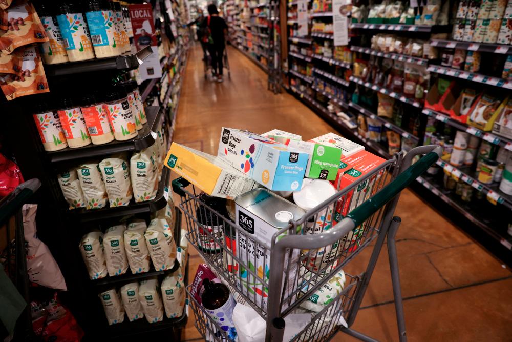 A shopping cart is seen in a supermarket in Manhattan, New York City. Consumption has provided a boost to the world’s biggest economy, giving it a strong start to 2023 but recent banking sector turmoil and higher interest rates weigh on the outlook. – Reuterspic