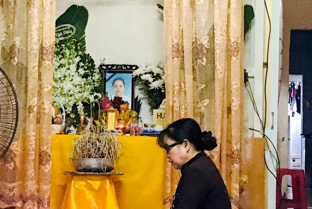 A woman prays at an altar with an image of Pham Thi Tra My, a victim of 39 deaths in a truck container in UK, at her home in Ha Tinh province, Vietnam October 27, 2019. - Reuters