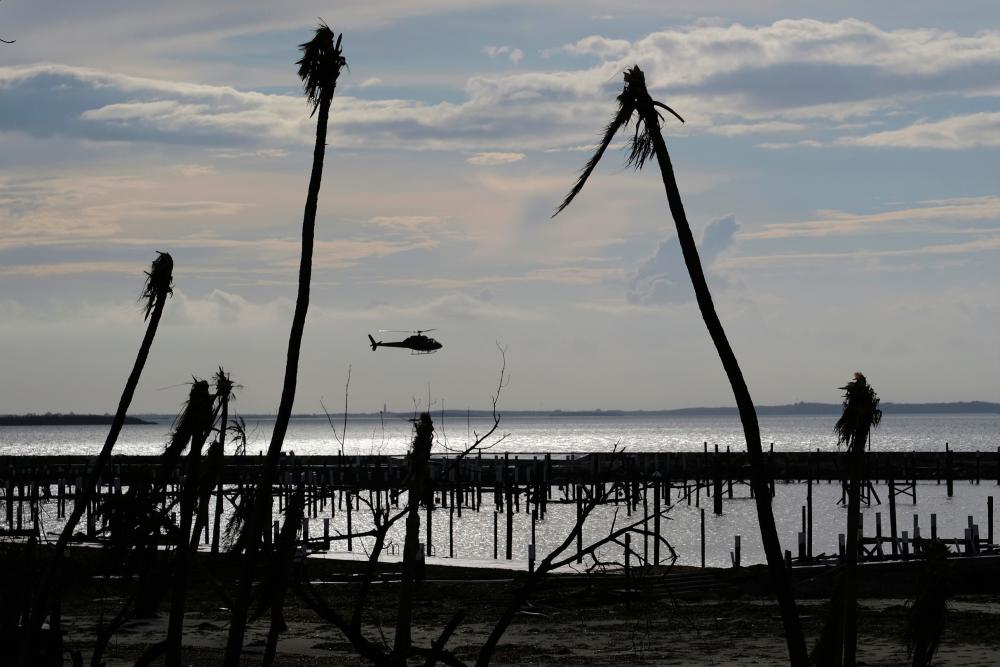 An unidentified helicopter lands to deliver food and water in the aftermath of Hurricane Dorian on the Great Abaco island town of Marsh Harbour, Bahamas, Sept 4, 2019. - Reuters