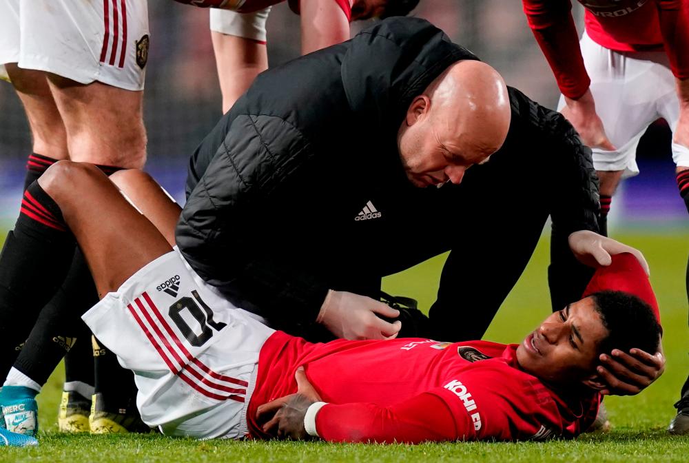 Manchester United's Marcus Rashford receives medical attention after sustaining an injury on January 15, 2020. - Reuters