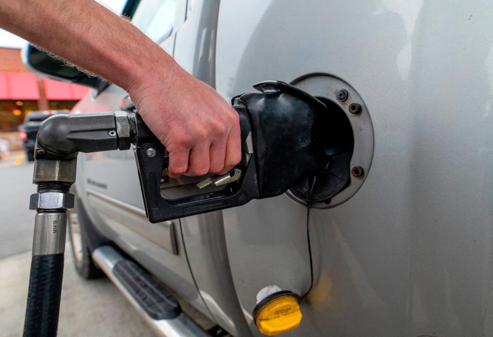 A motorist filling up at a petrol station in Plains, Pennsylvania. US petrol prices rebounded 3.8% in February after declining 3.3% in January. – Reuterspic