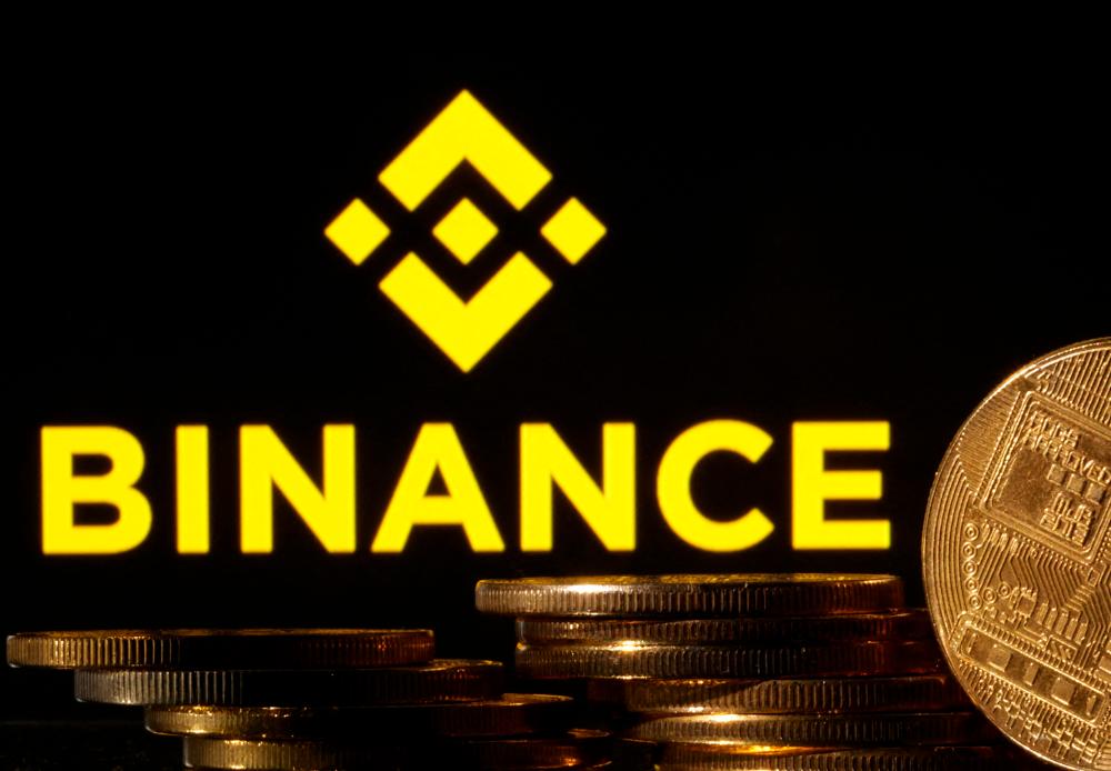 Representations of cryptocurrencies are seen in front of a displayed Binance logo in this illustration photo. – Reuterspic